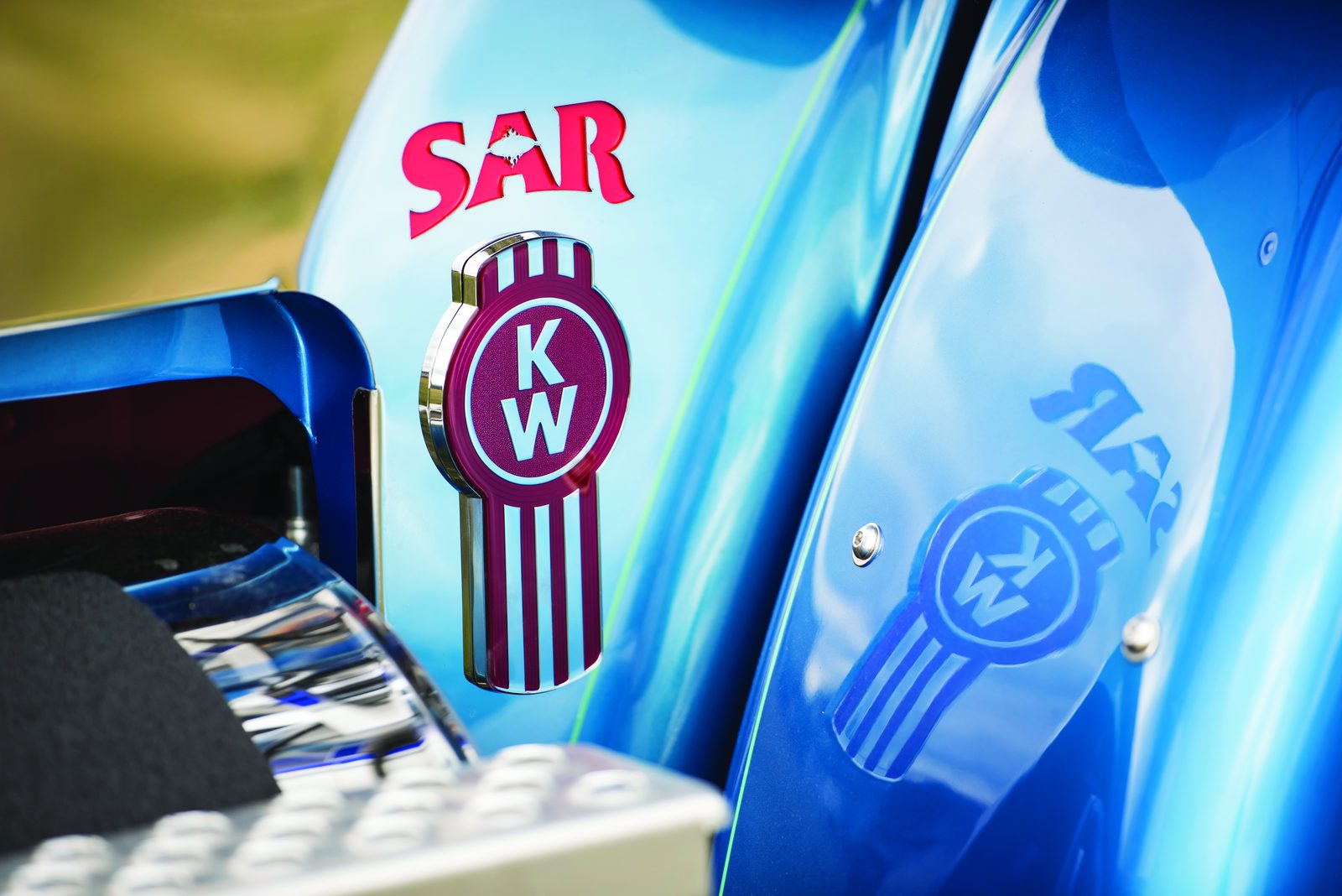 Close view of the SAR and Kenworth badges on Terry Thurwood’s blue truck