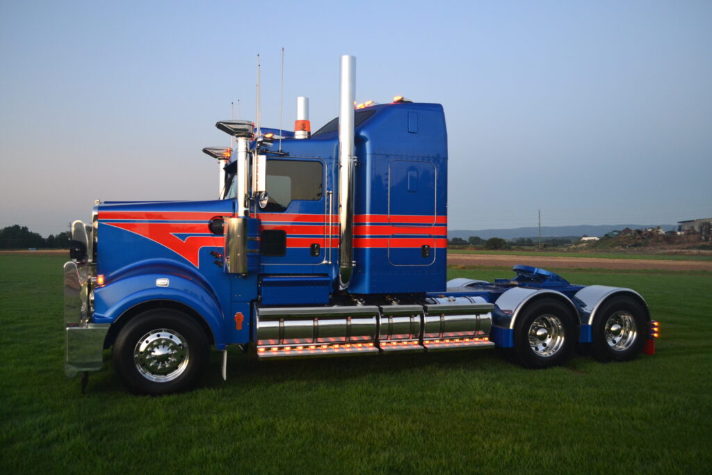 Blue and orange Davtrans Kenworth T909 photographed at dusk