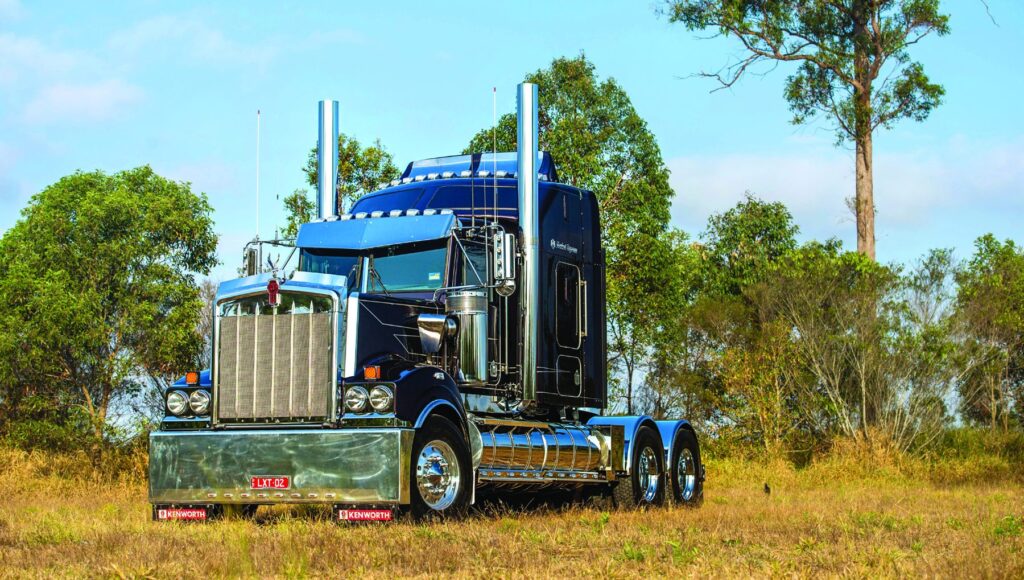 Bill Long’s dark Kenworth T900 parked outside in daylight