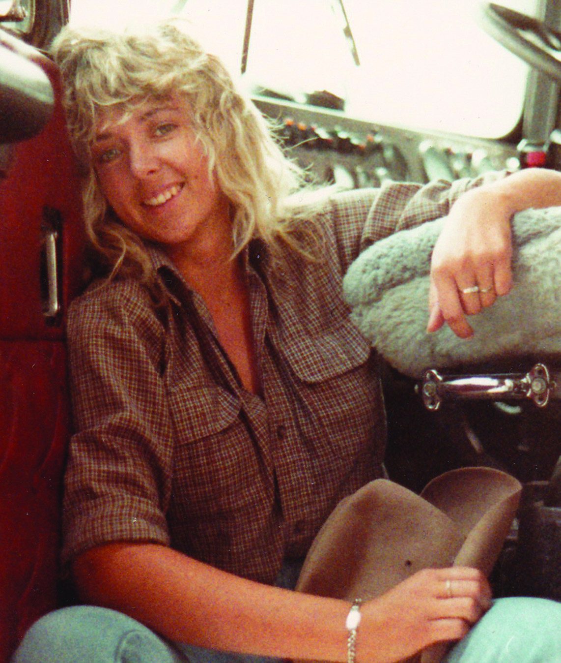 Tracey Rehe seated inside a truck cab in a period photograph