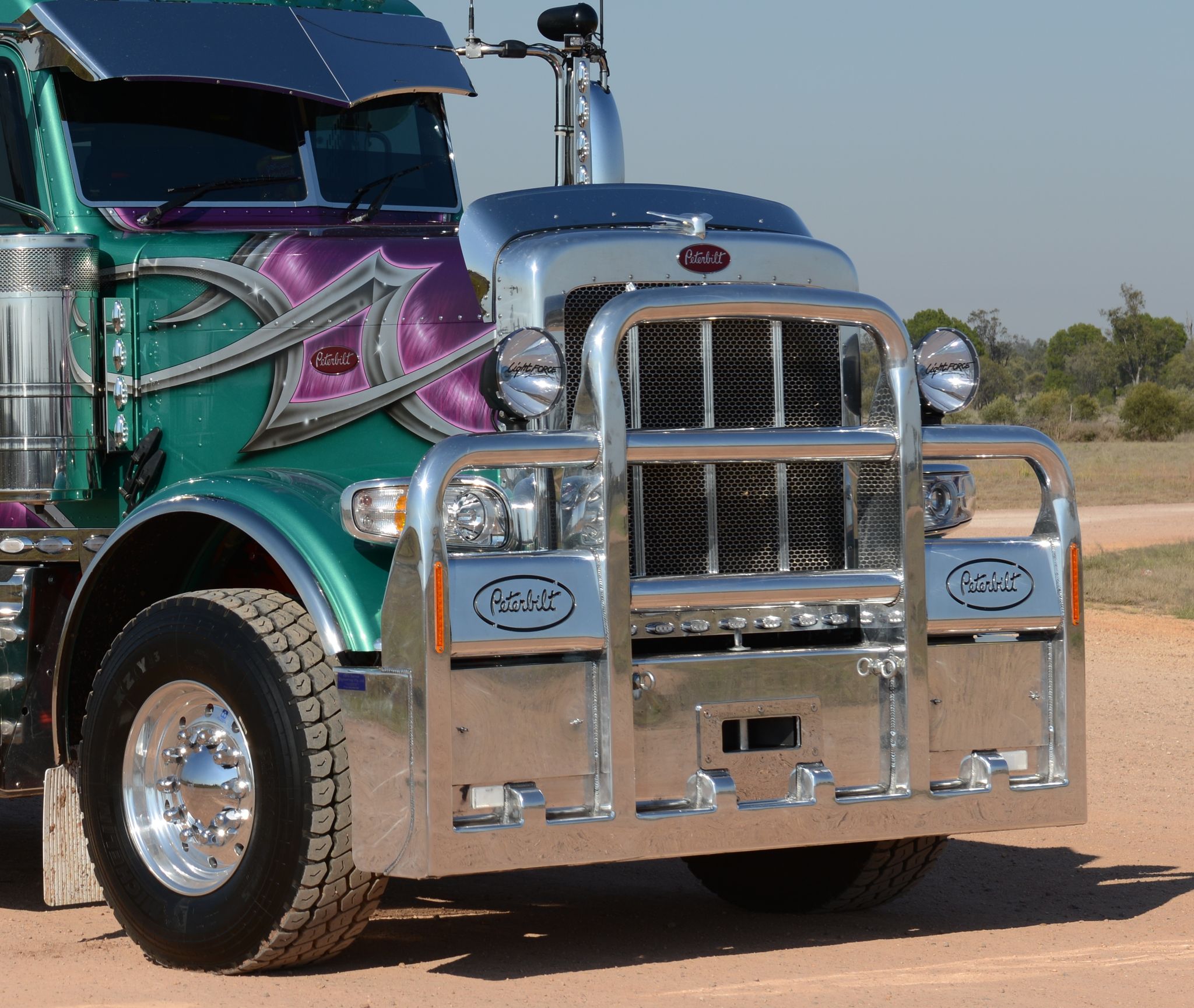 Front of Mike and Judy Oliver’s Peterbilt 388 with polished grille and custom bullbar