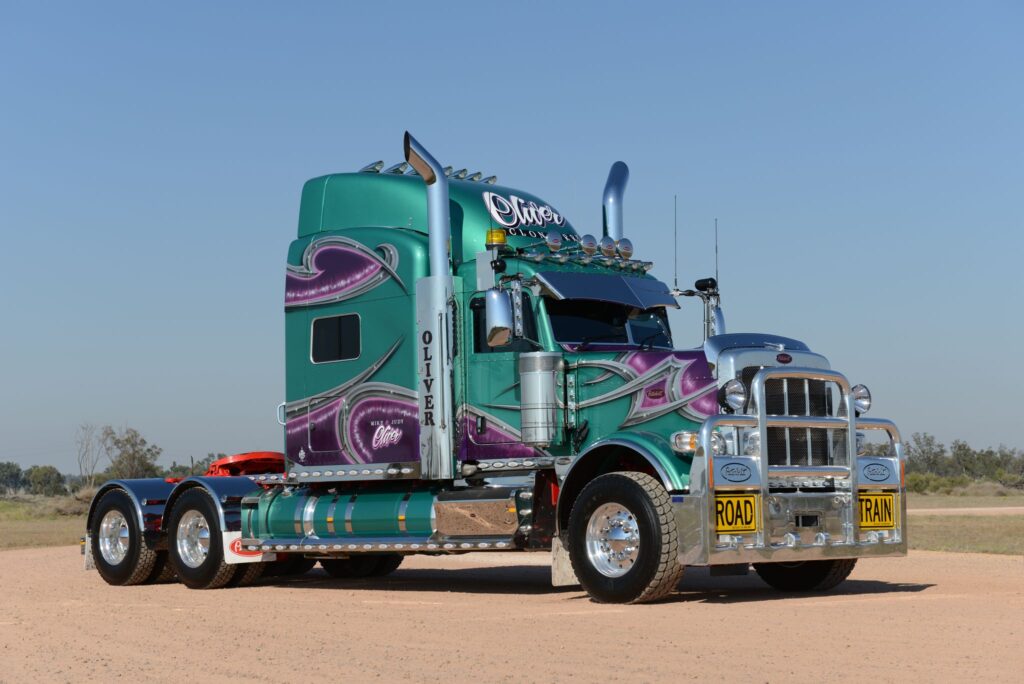 Mike and Judy Oliver’s green and purple Peterbilt 388 photographed three-quarter front in Queensland