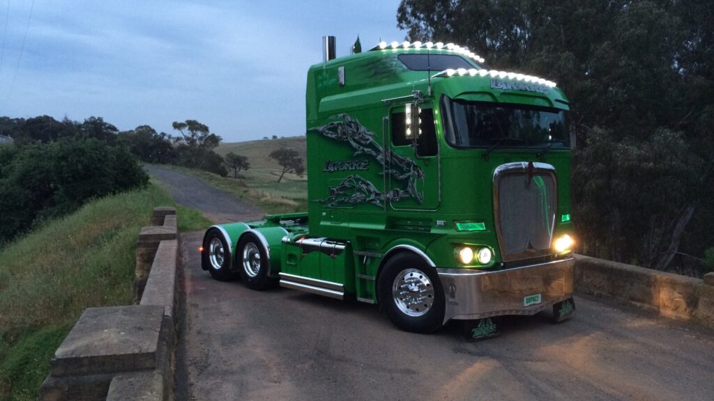 Anthony Latorre’s green customised Kenworth K200 photographed from the front at dusk