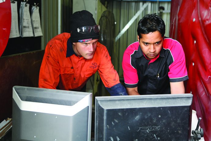 AJ’s Total Truck Gear staff reviewing a bullbar design in the workshop