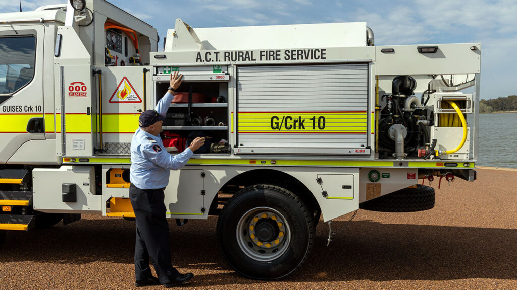 Guises Creek Brigade Captain Christopher Barnes beside one of the ACT Rural Fire Service's new heavy tanker trucks