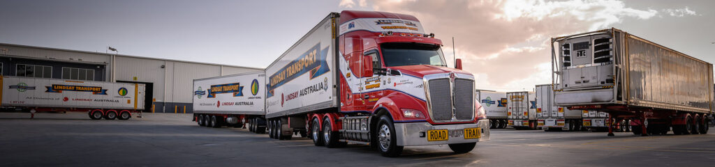 Lindsay Transport prime mover and refrigerated trailers at a transport depot