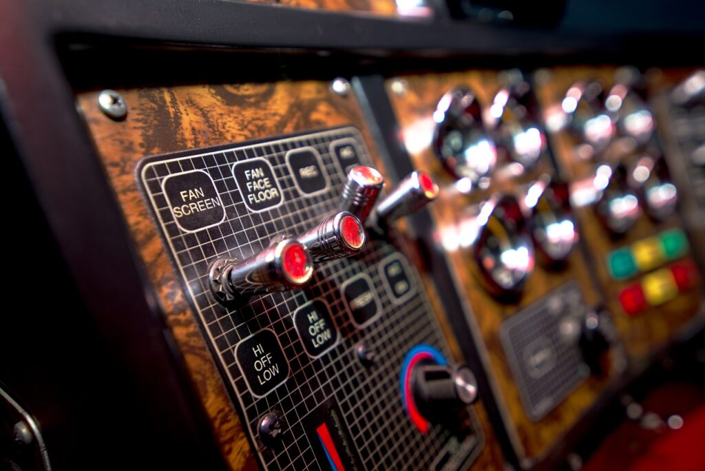 Close-up of dashboard switches and ventilation controls in Trevor Smith’s Kenworth K100E.
